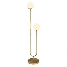 two light floor lamp in brass finish with white glass balls on the top and bottom