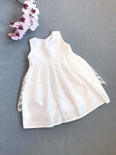 Silk dupioni dress and white organic cotton lining baby girl's christening/ baptism gown. Sleeveless, 3 pearl buttons closure at the back. Accented with off white lace on the chest and eyelash delicate lace on the skirt.  Available in sizes from 0 months to 5 years old.  Matching accessories can be made upon request, sold separately. Designer fabric organic cotton from USA. Handmade in Canada. Processed/made within 3-5 business days, shipping takes 7-10 business days regular mail. Express delive Elegant Baptism Dress For Spring, Elegant Spring Baptism Dress, First Communion Lace Patchwork Dress For Spring, First Communion Spring Dress With Lace Patchwork, First Communion Spring Dress With Lace Trim, Spring First Communion Dress With Lace Patchwork, White Lace Dress For Baptism In Spring, White Lace Dress For Spring Baptism, Spring Ceremony Lace Dress