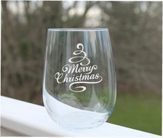 a wine glass that says merry christmas on it