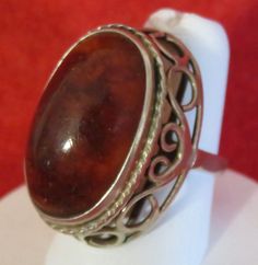 An Oversized 1970's Sterling Silver Ladies Amber Statement Ring (Size 7). Visit this shop for a wide variety of Vintage Quality Jewelry, Art, and Collectibles. ~Age (approximate): 1970's ~Material(s): Sterling Silver & Amber ~Approx. Size: 7 ~Approx. Weight: N/A ~Signature / Brand: Unsigned. ~Condition: Very Good. ~International Shipping: Is Available, please contact us for a quote. ~Inventory #: 7038 Vintage Brown Hallmarked Ring, Brown Hallmarked Vintage Ring, Vintage Collectible Rings With Large Stone, Vintage Rings With Large Stone For Collectible, Vintage Rings With Large Stone For Collectors, Vintage Oval Dome Ring Gift, Vintage Oval Dome Ring As A Gift, Vintage Hallmarked Dome Ring, Vintage Round Rings With Large Stone