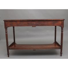 an old wooden table with two shelves on each side and one shelf below the top