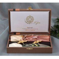 an open gift box with ties in it