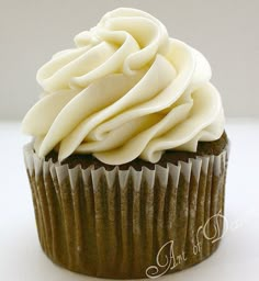 a chocolate cupcake with white frosting on top