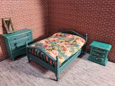 a dollhouse bedroom with a bed, nightstands and mirror on the floor in front of a brick wall