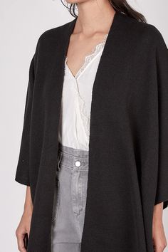 Throw on the River City Black Cardigan for a cozy chic up-to-the-minute look! You'll be ready for cooler weather and look good at the same time. Black lightweight knit forms and open front cardigan sweater, with poncho style sleeves, and open side slits. Chic Open Front Sweater For Layering, Chic Open Front Layering Sweater, Chic V-neck Sweater Coat For Layering, Versatile Black Cardigan For Daywear, Trendy Winter Cardigan For Daywear, Chic Wrap Cardigan For Layering, Versatile Open Front Sweater For Layering, Versatile Open Front Cardigan For Layering, Fall Wrap Cardigan For Layering