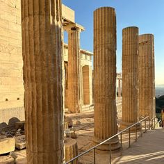 some very tall stone pillars in the middle of a building