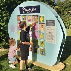 two young children are playing with a poster