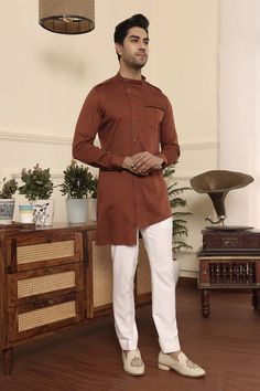 Rust full sleeve kurta with front button placket and asymmetric hem. Paired with pant. - Aza Fashions Long Sleeve Cotton Bandhgala For Eid, Casual Long Sleeve Brown Kurta, Casual Brown Long Sleeve Kurta, Cotton Kurta For Work With Long Sleeves, Designer Cotton Bandhgala With Long Sleeves, Fitted Long Sleeve Kurta For Workwear, Fitted Long Sleeve Kurta For Fall, Brown Fitted Long Sleeve Kurta, Traditional Long Sleeve Nehru Jacket For Workwear