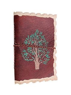 a notebook with a tree on the front and green leaves on the back, tied in twine