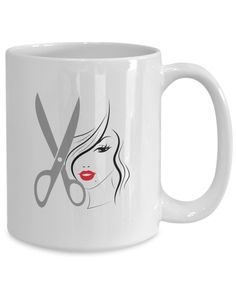 a white coffee mug with scissors and a woman's face on the front side