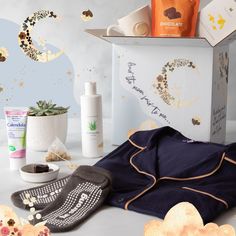 the contents of a women's gift box including socks, body lotion and hand sanitizers