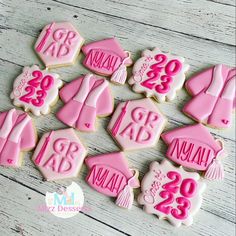 decorated cookies with pink frosting on a wooden table