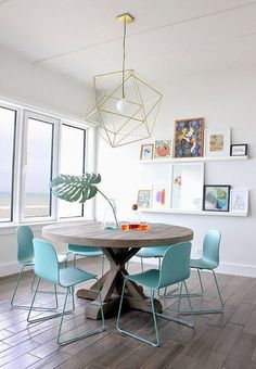 a dining room table with blue chairs around it