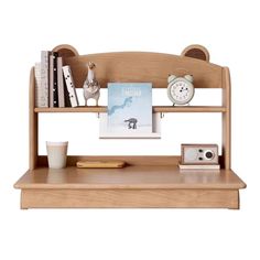 a wooden shelf with books, pictures and other items on it next to a cup