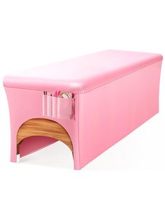 a pink storage bench with drawers on the top and bottom section, sitting against a white background