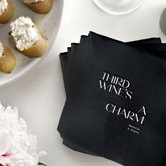 there is a napkin with the words third wines charm on it next to some cupcakes