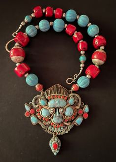 Antique Himalayan Nepalese Tibetan Turquoise and Coral Pendant - Etsy Red Bohemian Necklace With Large Pendant, Bohemian Turquoise Necklace With Red Coral For Gift, Artisan Red Carved Jewelry, Traditional Red Carved Necklace, Artisan Red Coral Beaded Necklaces, Red Amulet Necklace For Rituals, Traditional Beaded Necklace With Red Coral And Natural Stones, Red Amulet Necklaces For Rituals, Handmade Turquoise Necklace With Red Coral