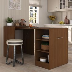 a kitchen with a counter, stools and cabinets