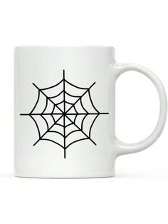 a white coffee mug with a spider web on it