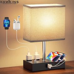 an electronic device is plugged in to a table lamp with the charger attached