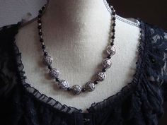 This gorgeous 18" necklace is made of black glass beads with silver metal embellishments.  How beautiful this would look with that basic black dress!! Nickel-free Black Beaded Necklaces With Round Beads, Nickel Free Black Beaded Necklaces, Silver Gothic Necklace With Black Beads, Gothic Silver Beaded Necklaces With Black Beads, Gothic Silver Necklace With Black Beads, Black Metal Necklace With Silver Beads, Black Metal Necklaces With Silver Beads, Elegant Metal Necklaces With Spacer Beads, Black Necklace With Silver Beads