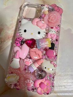 the hello kitty phone case has many different items on it