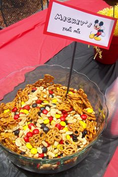 a mickey mouse dessert in a glass bowl on a table with a sign that says disney's frank mix