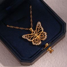 Description:Filled Hollowed-out Butterfly Chain NecklaceSpecifications:Material: cubic zirconia, stainless steel, 24k goldColors: goldSize: 40 cm + 5 cm extWeight: 6.5 g/pcs "Flutter with style with our Filled Hollowed-out Butterfly Chain Necklace. This unique necklace features a hollowed-out butterfly design that's filled with charm and elegance. A perfect accessory to complete your playful and quirky look. Get ready to spread your wings!" Gold Rhinestone Necklace With Clavicle Chain, Gold Cubic Zirconia Necklace With Adjustable Chain, Gold Necklace In Alloy, Gold Chain Alloy Necklace As Gift, Gold Chain Necklace In Alloy, Gold Rhinestone Pendant Necklace, Gold Alloy Chain Necklace, Gold Alloy Necklaces As Gift, Gold Plated Rhinestone Necklace With Adjustable Chain