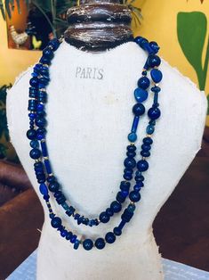 Double or triple duty! The beautiful deep blue of Afghanistan Lapis ~ in varying shapes and sizes and measuring 42" long ~ can be worn as a single strand, double strand or even a bracelet. A true triple treat! 💙 Rounds, discs, cylinders and hearts 💙, as well as some gold Thai Trade Beads and a few Chacedony, Glass and Sodalite beads for variety are part of this unique neck piece.  A golden lobster clasp and tiny Golden Bronze star ⭐️ and Lapis charm finish the closure. This beauteous blue bauble will arrive gift 🎁 wrapped for gifting or wearing.  Feel free to Convo me and please visit my other Etsy shop: BohoBeadsBySusyQ 😀 Blue Long Hand-strung Necklace, Blue Hand-strung Long Necklace, Blue Long Layering Necklace, Blue Long Necklace For Layering, Blue Gemstone Beads Long Necklace Gift, Bohemian Blue Long Necklace With Faceted Beads, Blue Gemstone Beads Necklaces For Layering, Blue Multi-strand Jewelry For Layering, Hand-strung Blue Multi-strand Necklace