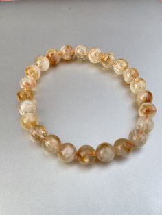 AAA+ Natural Citrine Bracelet ,8mm Citrine Bracelet, Citrine Jewelry, Gemstone Beaded Bracelet, Citrine Crystal Bracelet, Abundance Bracelet, Energy Bracelet, Happiness ,Cabochon . Handmade item Materials: Gemstone Shape: Round  Citrine is a stone of warm energy and brings optimism. It brings professional and career growth and works on material abundance. It is known as the manifestation stone and clears any negativity without absorbing it. Delivery details: ✓ Free Shipping With safe Packing ✓ Your most welcome Here ❤️ We Design Our All Products in Natural Stones With Perfections And Artmanship Our all Products Are Purely HandCarved with Hand Machine tools Feel Free To Ask Any Query of Yours We Definitely Reply With our Best ❤️ - Shyam Gem Carvings Thanks for visiting the shop have a nice Amber Gemstone Beads Bracelets, Amber Gemstone Beaded Bracelets With Round Beads, Amber Round Beaded Bracelets With Natural Stones, Handmade Amber Crystal Bracelet With Round Beads, Amber Gemstone Beaded Bracelets, Amber Gemstone Beads Bracelet, Amber Bracelets With 8mm Round Beads, Orange Gemstone Beaded Bracelets With Round Beads, Orange Gemstone Beaded Bracelets