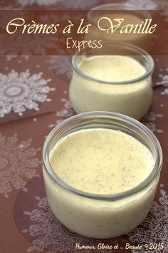 two jars filled with cream sitting on top of a table