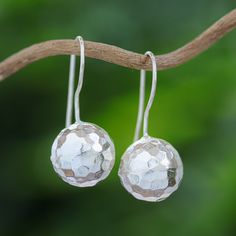 Presented by Wadarat Supasirisuk, this pair of drop earrings displays the exquisite nature of Thai handicrafts. Each earring is crafted of sterling silver, featuring a spherical disco ball shape with a hammered finish. Pierced Sphere Sterling Silver Earrings, Pierced Sterling Silver Sphere Earrings, Sterling Silver Sphere Earrings, Silver Spherical Earrings As Gift, Sterling Silver Sphere Earrings For Gift, Disco Style, Sterling Silver Drop Earrings, Silver Dangle Earrings, Earring Display