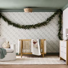 a baby's room decorated for christmas with greenery