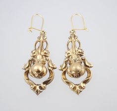 A beautiful large pair of antique Victorian 15k gold dangling pear floral earrings dating to circa 1880. These large and fabulous Victorian solid 15k yellow gold dangling earrings have a classic Victorian hollow construction for wearing comfort and have an unusual design of a wonderful 3D pear fruit with leaves wrapped around the top, framed within a dangling swinging pendulum of scrolls which shimmers and shakes beautifully whenever the head is moved, the pear suspended from a fantastic bouquet Antique Drop Earrings With Historical Design, Antique Gold Earrings With Historical Design, Victorian Yellow Gold Earrings With Intricate Design, Victorian Yellow Gold Drop Earrings, Ornate Gold Earrings With Historical Design, Antique Wedding Earrings With Historical Design, Vintage Historical Design Earrings For Wedding, Antique Yellow Gold Earrings For Wedding, Ornate Historical Design Earrings