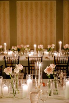 the table is set with candles and flowers