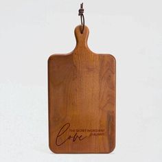 a wooden cutting board with the words love on it