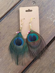 Beautiful handmade bohemian  feather earrings.  Hypoallergenic. Natural peacock feathers. Green Bohemian Earrings With Feathers, Green Bohemian Feather Earrings, Bohemian Green Feather Earrings, Bohemian Peacock Earrings For Gift, Bohemian Peacock Earrings As Gift, Peacock-colored Bohemian Earrings For Gift, Peacock Bohemian Earrings For Gift, Peacock Bohemian Earrings As Gift, Bohemian Green Earrings With Peacock Design