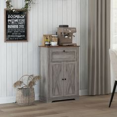 a room with a table, chair and chalkboard on the wall next to it