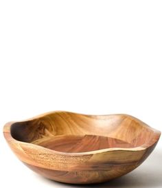 a wooden bowl sitting on top of a white table