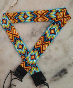 a beaded triangle on a marble surface