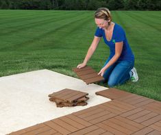 a woman kneeling on the ground next to a piece of wood that has been cut into pieces