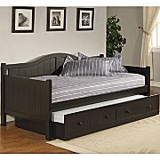 a day bed with trundle drawers underneath it