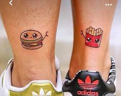 two people with tattoos on their legs and one has a hamburger and fries in it