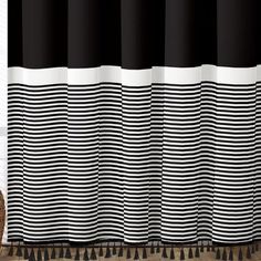 a black and white striped curtain hanging on a wall