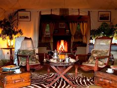 a living room filled with furniture and a fire place in the middle of a room