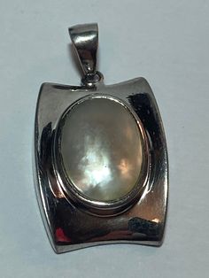 Pearl Sterling Pendant Don Lucas MOP Mother 925 Silver 4 Necklace Vintage Jewelry Southwestern Anniversary Christmas Birthday Gift Bridal https://www.etsy.com/listing/1496782708/pearl-sterling-pendant-don-lucas-mop Luxury Mother Of Pearl Round Pendant Jewelry, Antique Silver Jewelry With Pearl Pendant, Silver Antique Jewelry With Pearl Pendant, Silver Oval Pendant Necklace Stamped 925, Silver 925 Stamped Oval Pendant Necklace, Southwestern Silver Necklace With Oval Pendant, Vintage Sterling Silver Jewelry With Pearl Pendant, Classic Silver Oval Pendant Jewelry, Silver Oval Pendant With Polished Finish