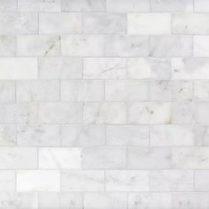 a white marble tile wall that looks like it has been made out of different types of tiles