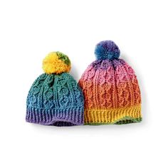 two knitted hats with multicolored pom poms on each one side