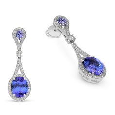 Raise the fashion bar with these alluring blue tanzanite and diamond drop earrings. Created in 18K white gold, each dangle shimmers with diamonds to highlight an oval-cut blue tanzanite framed by a diamond pave halo. Diamonds line the unique drop design to complete this elegant look. 
11.69 carat Oval cut Tanzanite earrings 
1.14 carat white diamonds
The earring design can be customized to suit your particular taste & budget with any Size, Color & Clarity Combination of Ce Luxury Oval Sapphire Diamond Earrings, Luxury Tanzanite Earrings With Gemstone, Luxury Tanzanite Gemstone Earrings, Luxury Tanzanite Drop Earrings, Classic Blue Oval Diamond Earrings, Luxury Round Tanzanite Earrings, Oval Gemstone Earrings For Formal Occasions, White Gold Tanzanite Earrings With Brilliant Cut, Elegant Tanzanite Formal Earrings