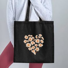 This Daisy Flower Heart Tote Bag is a charming addition to your daily essentials. Perfect for shopping, school, or beach outings, this cute floral tote bag features a heart-shaped daisy design that adds a touch of summer fashion to your style. It makes a thoughtful and practical gift for her, ideal for birthdays, anniversaries, or just because. Show off your eco-friendly side with this stylish and versatile tote bag that combines functionality with a love for nature.  TOTE BAG FEATURES:  Fabric: Trendy Flower-shaped Bag For Gifts, Casual Bags For Mother's Day Gifts, Casual Mother's Day Gift Bags, Heart-shaped Bags For Everyday Spring Use, Heart-shaped Spring Bags For Everyday Use, Heart-shaped Spring Bags For Everyday, Heart-shaped Everyday Bags For Spring, Casual Bags For Valentine's Day Gift, Casual Bag For Valentine's Day Gift